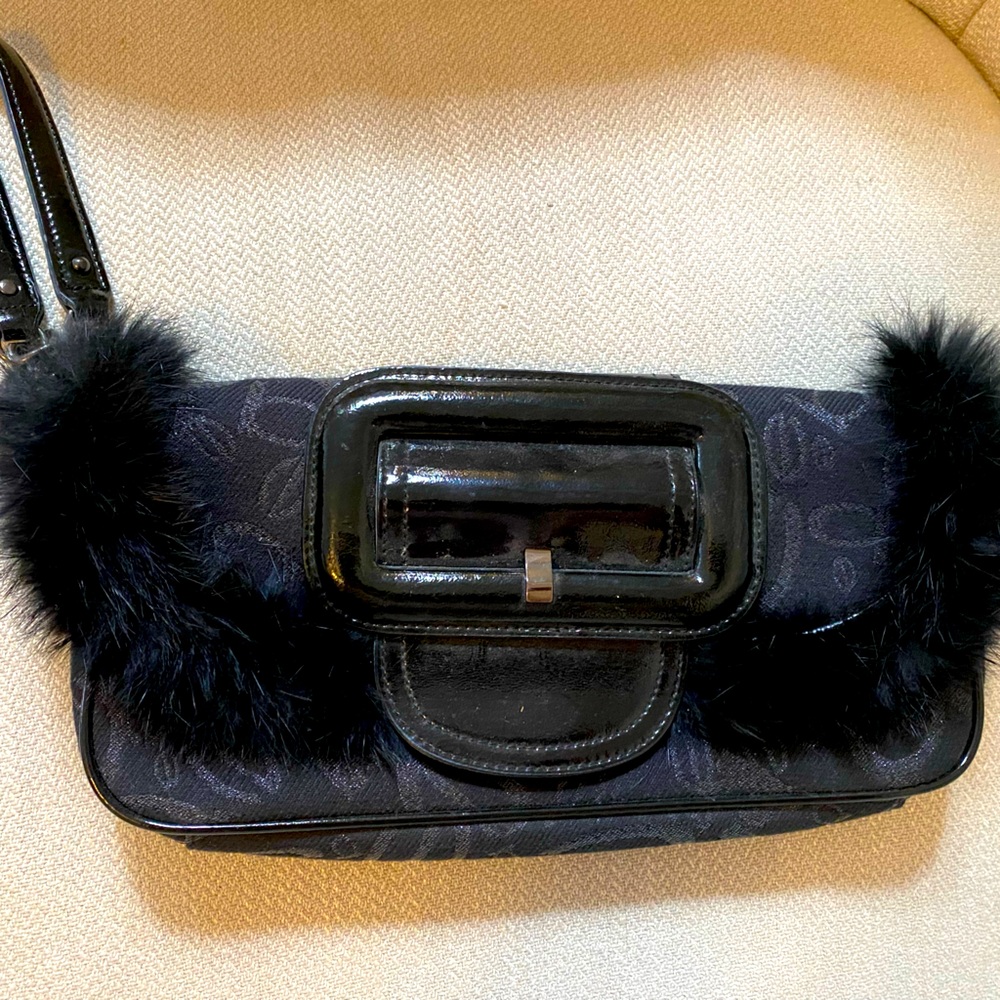 BEBE faux fur lined clutch in black.